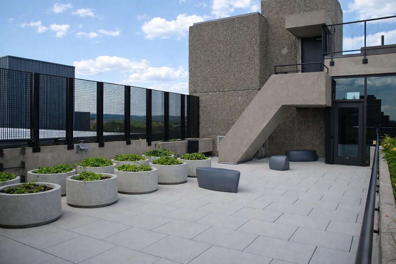 Rooftop terrace with planters and seating.